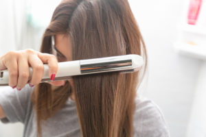 girl straightening hair